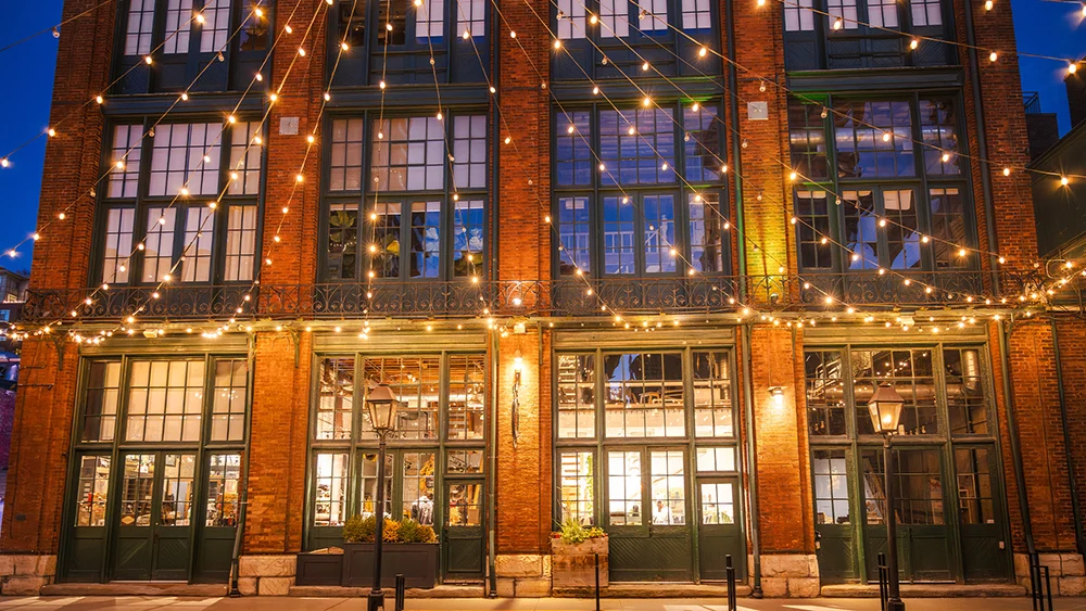 Heritage building with long strands of lights in front of it